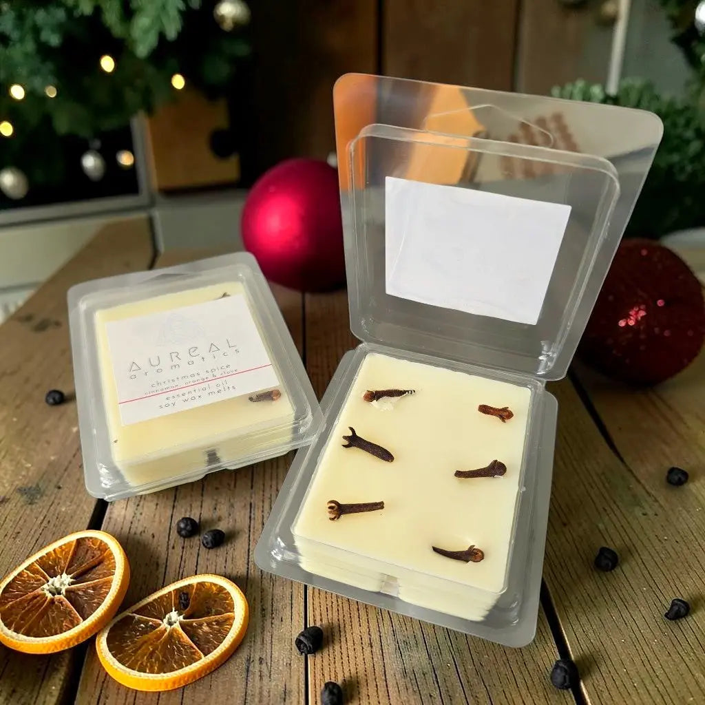 Aureal Christmas Spice soy wax melts with cloves in an open clear pack, orange slices
