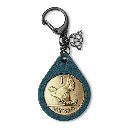 Irish penny with a hen design in a blue teardrop keyring with a black clip and Celtic knot charm
