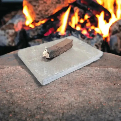 Lit turf sod on a slate in front of an open fire