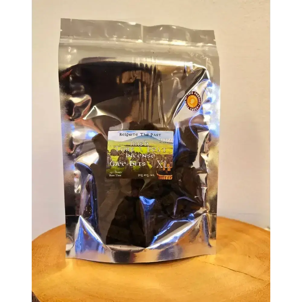 Silver resealable bag of Irish Turf Peat Incense Wee Bits on a wooden board