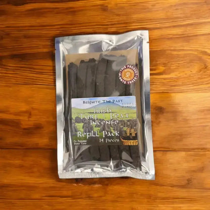 Irish Turf Peat Incense Refill Pack in a silver foil bag on a wooden table