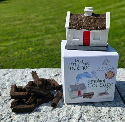 Cottage burner on top of its Smoking Cottage Set box, turf sods on the stone beside it